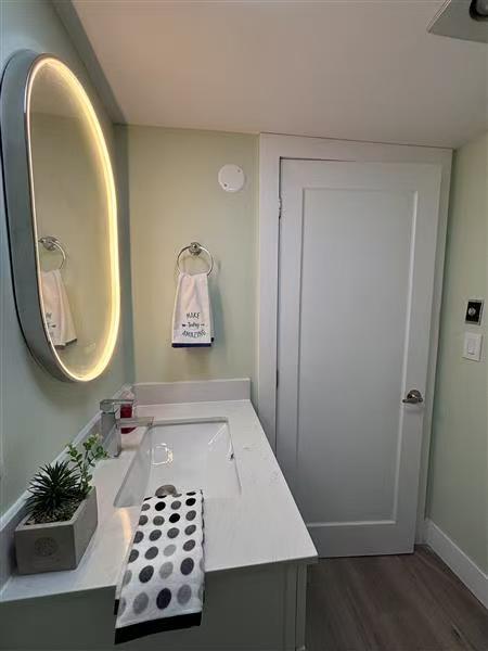 Spotless modern bathroom with backlit oval mirror — completed Zulma deep clean