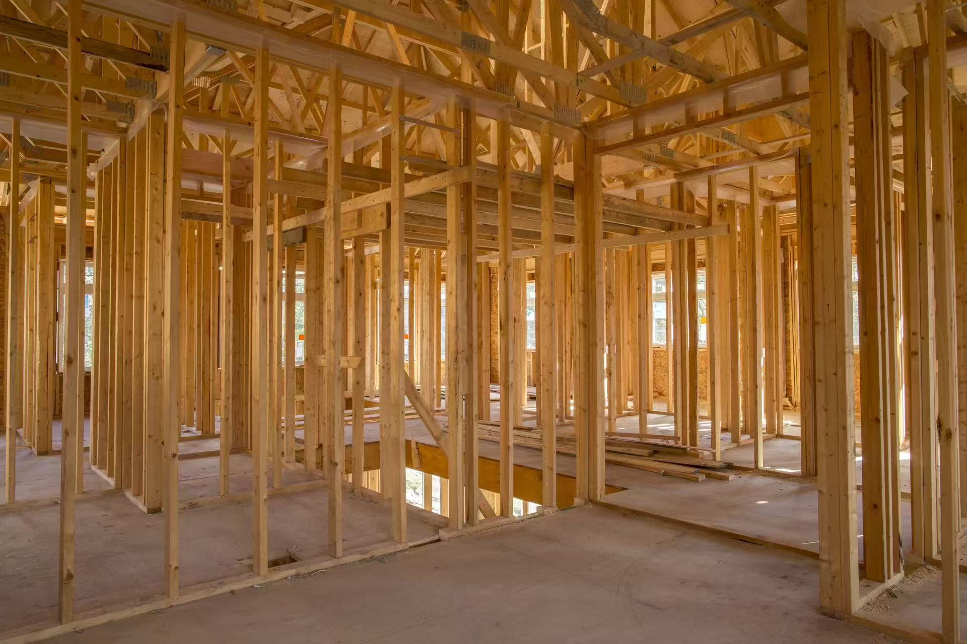 Wood framing of a new home interior with exposed studs and joists